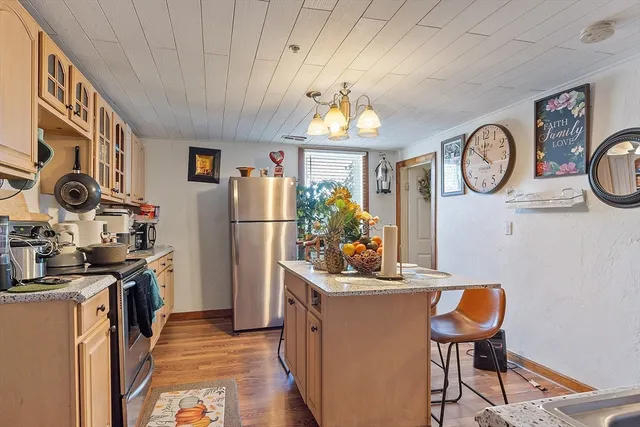 a view of a kitchen with fridge and rack
