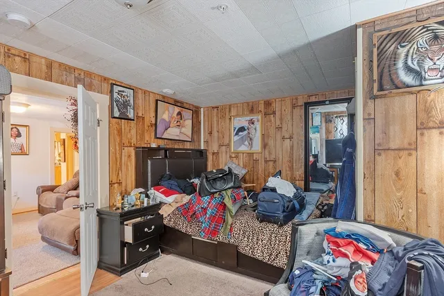 a bedroom with furniture and a flat screen tv