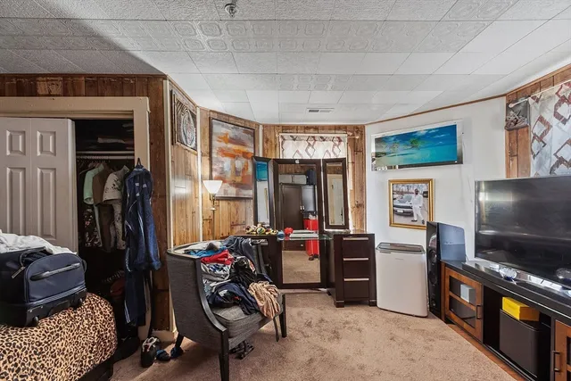a view of a livingroom with workspace and a window