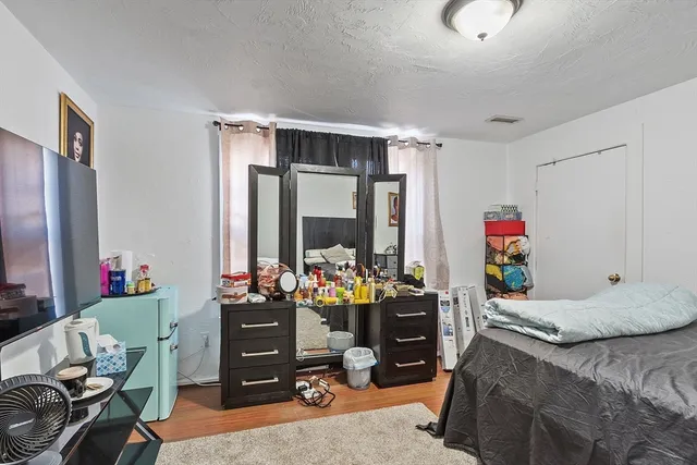 a bedroom with furniture and a large window