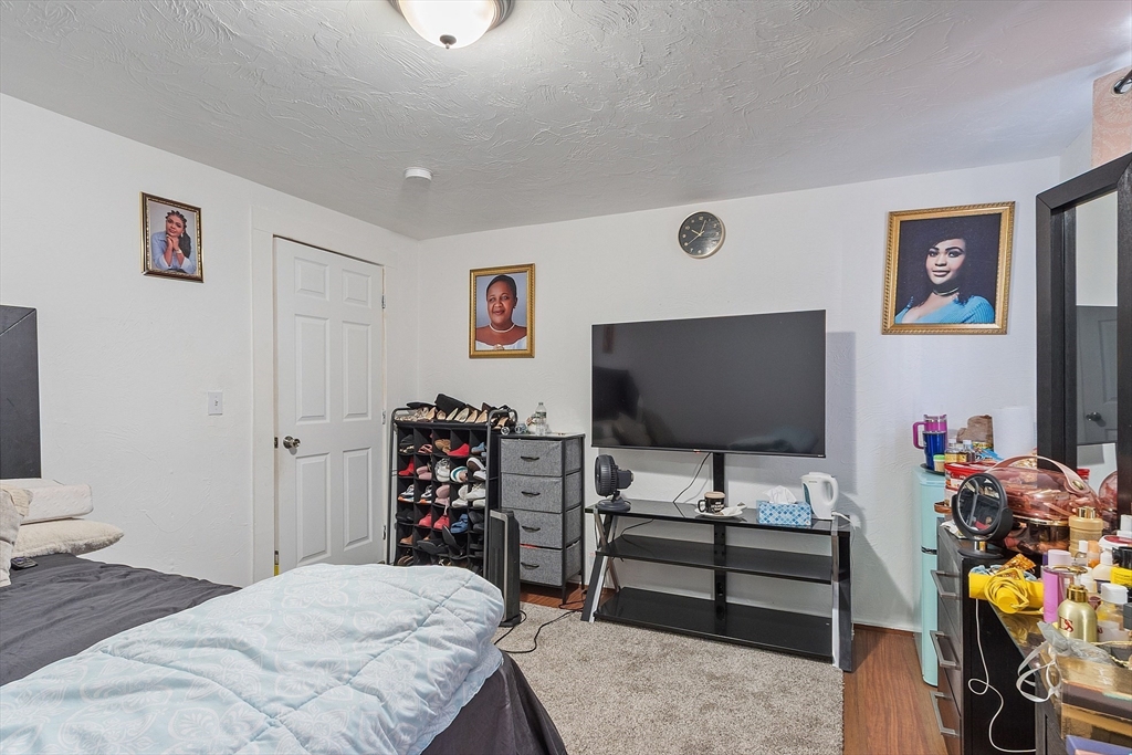 40 Aetna Street Worcester, MA 01604 - Photo 35 of 42 a bedroom with a bed and a flat screen tv
