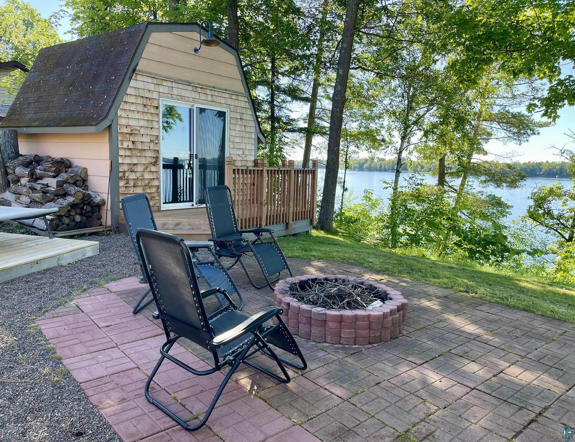 37460 Sunrise View Road Sturgeon Lake, MN 55783 - Photo 46 of 50 Fireside patio & Lakeside bar/bunkhouse.