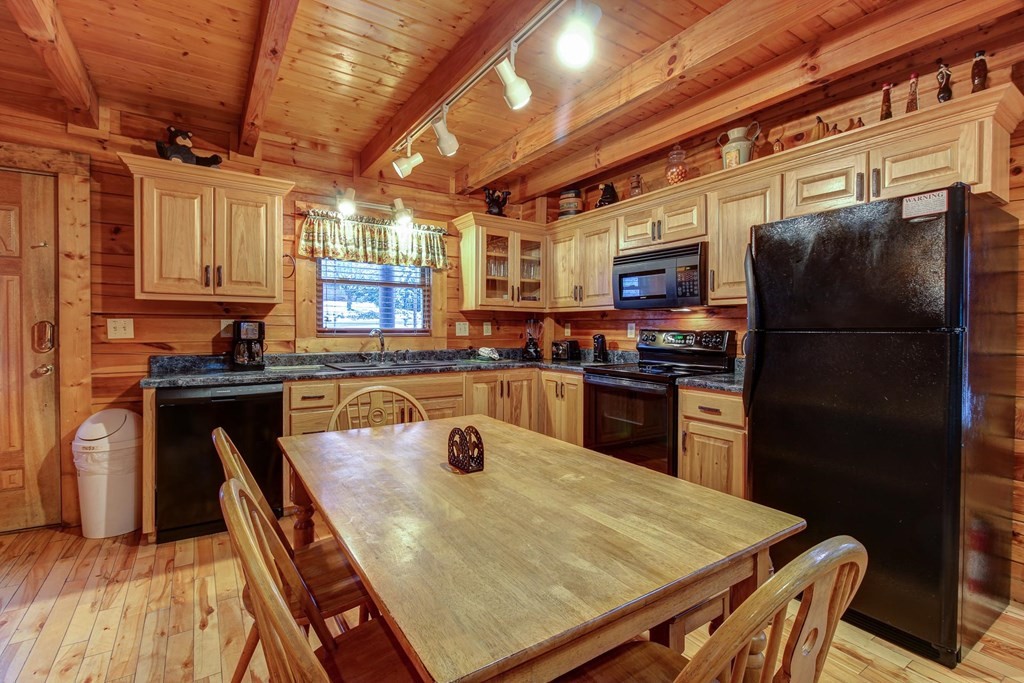 2010 Goose Gap Road Sevierville, TN 37876 - Photo 8 of 33 a kitchen with a refrigerator a sink and wooden cabinets