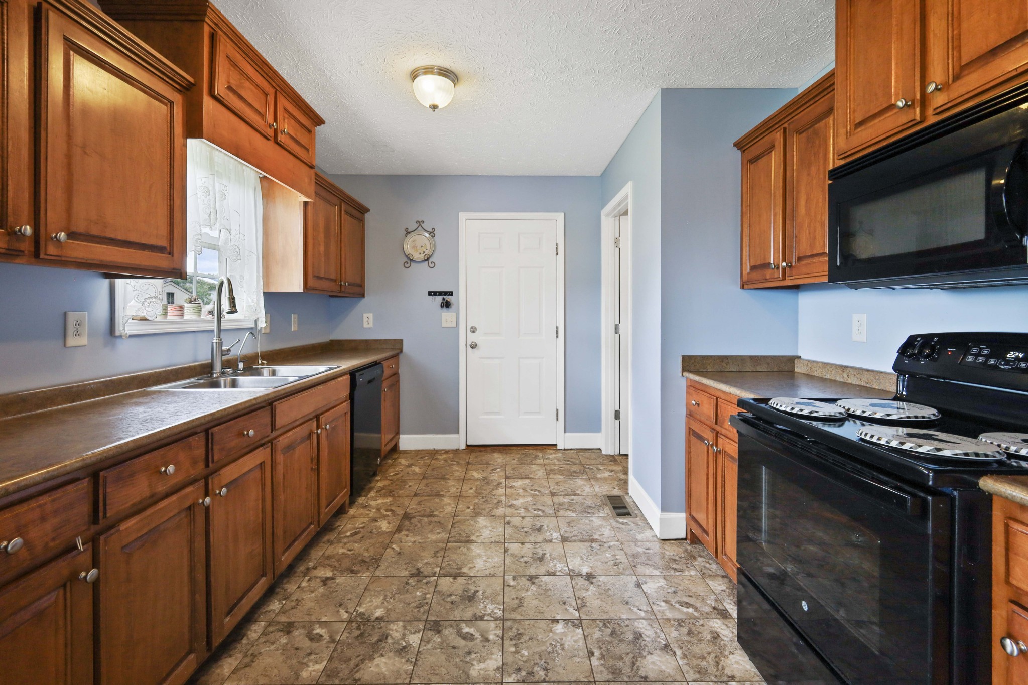 395 Lear Road Portland, TN 37148 - Photo 14 of 34 a kitchen with stainless steel appliances granite countertop a stove a sink and a microwave