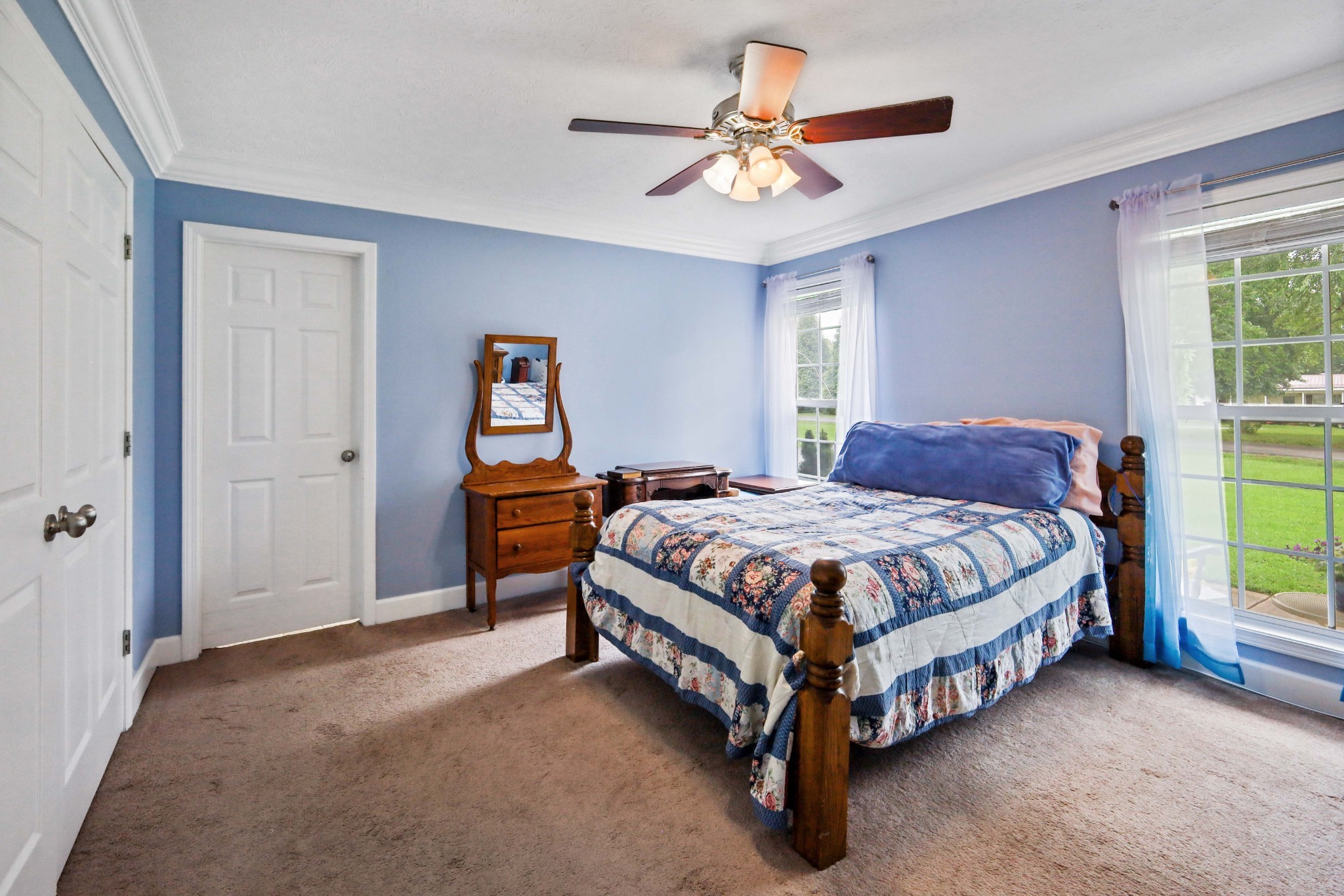 395 Lear Road Portland, TN 37148 - Photo 15 of 34 a spacious bedroom with a bed and a chandelier