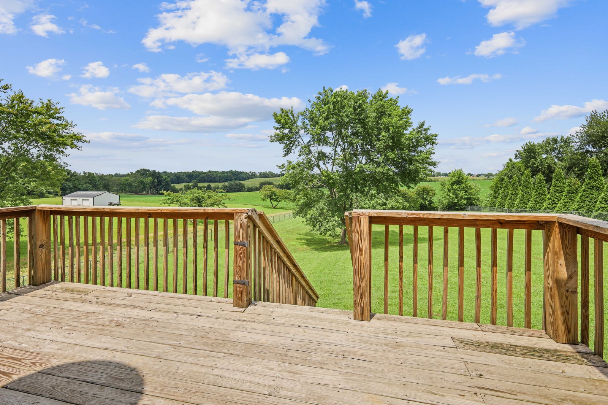 395 Lear Road Portland, TN 37148 - Photo 21 of 34 a balcony with wooden floor and trees in the background
