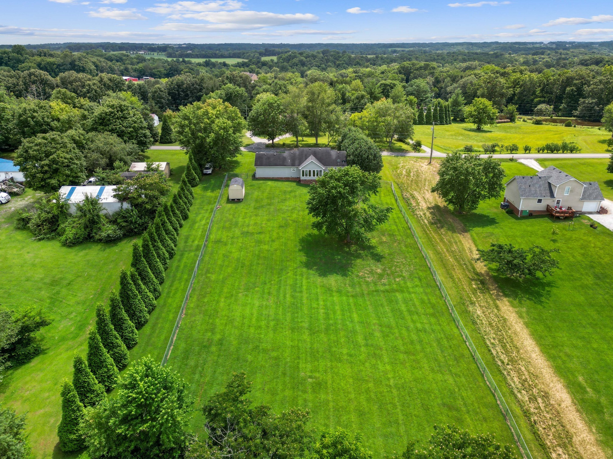 395 Lear Road Portland, TN 37148 - Photo 23 of 34 a view of a lush green forest with a houses