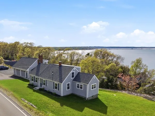 a aerial view of a house with a garden and lake view