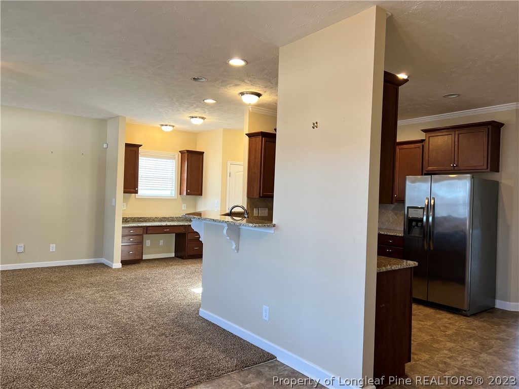 4775 McKinnon Farm Road Fayetteville, NC 28304 - Photo 13 of 45 a view of a kitchen with a sink and refrigerator