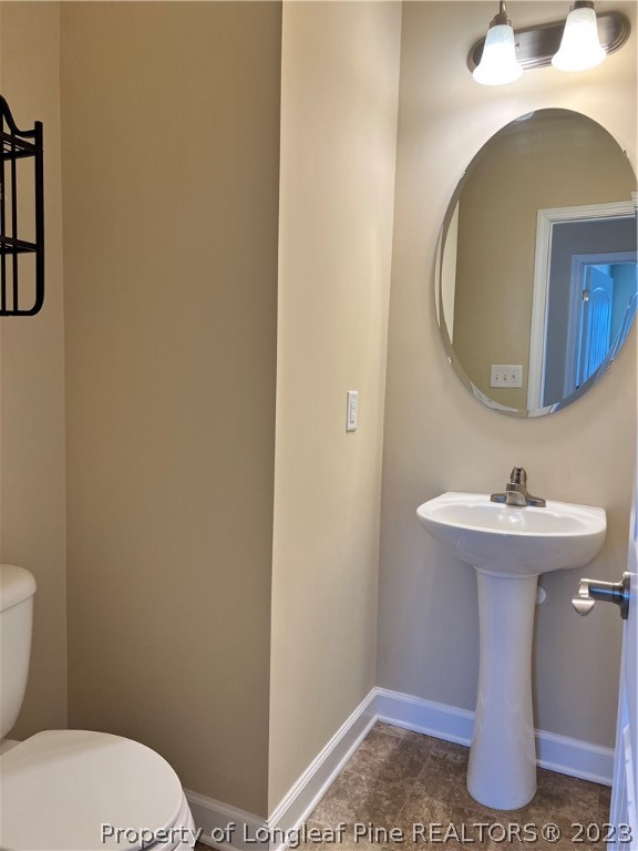 4775 McKinnon Farm Road Fayetteville, NC 28304 - Photo 16 of 45 a bathroom with a sink a toilet and mirror