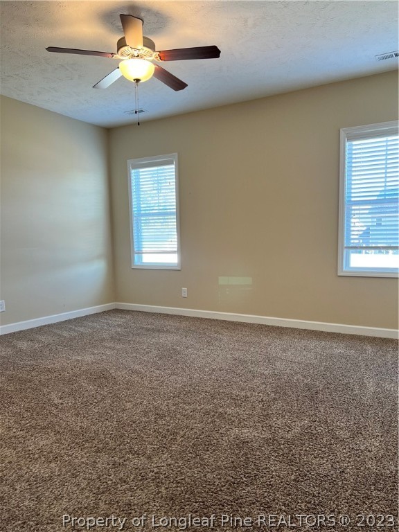 4775 McKinnon Farm Road Fayetteville, NC 28304 - Photo 17 of 45 an empty room with windows and chandelier fan