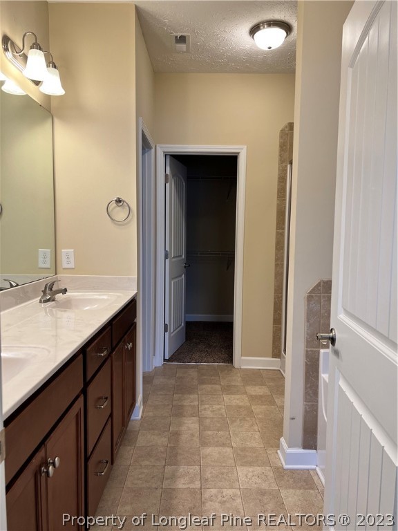 4775 McKinnon Farm Road Fayetteville, NC 28304 - Photo 20 of 45 a bathroom with a double vanity sink a mirror and a shower