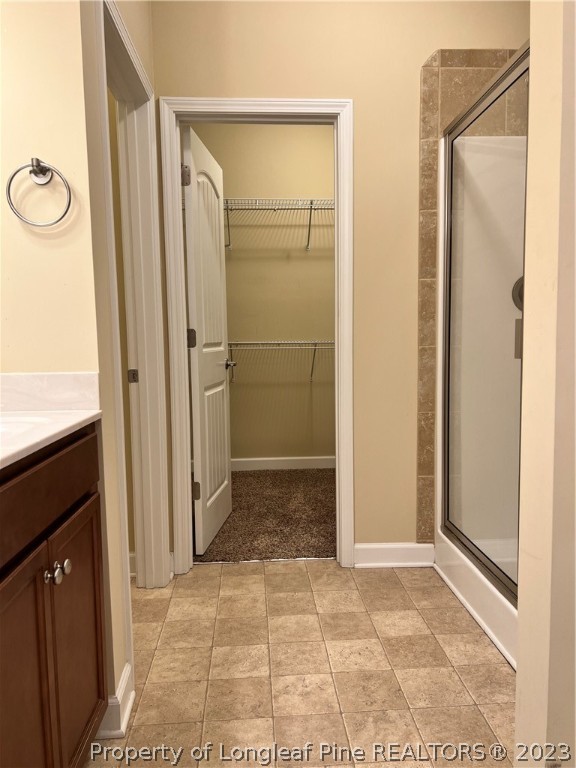 4775 McKinnon Farm Road Fayetteville, NC 28304 - Photo 21 of 45 a bathroom with a glass shower door and a sink