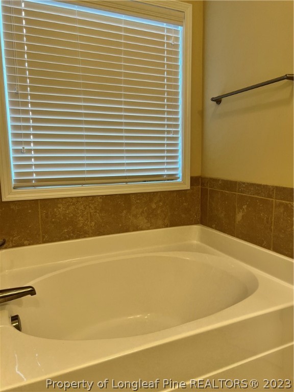 4775 McKinnon Farm Road Fayetteville, NC 28304 - Photo 23 of 45 a bathroom with a bathtub and a shower