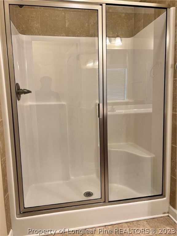 4775 McKinnon Farm Road Fayetteville, NC 28304 - Photo 25 of 45 a bathroom with a glass shower door