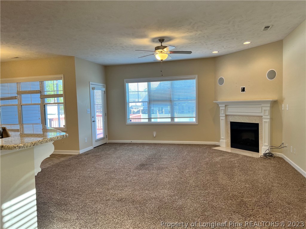 4775 McKinnon Farm Road Fayetteville, NC 28304 - Photo 9 of 45 a view of an empty room with a fireplace and a window