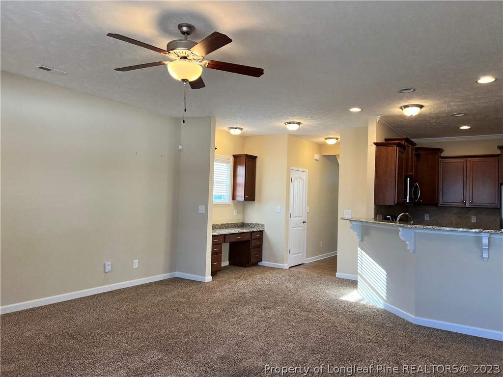 4775 McKinnon Farm Road Fayetteville, NC 28304 - Photo 10 of 45 a large kitchen with a sink stainless steel appliances and cabinets