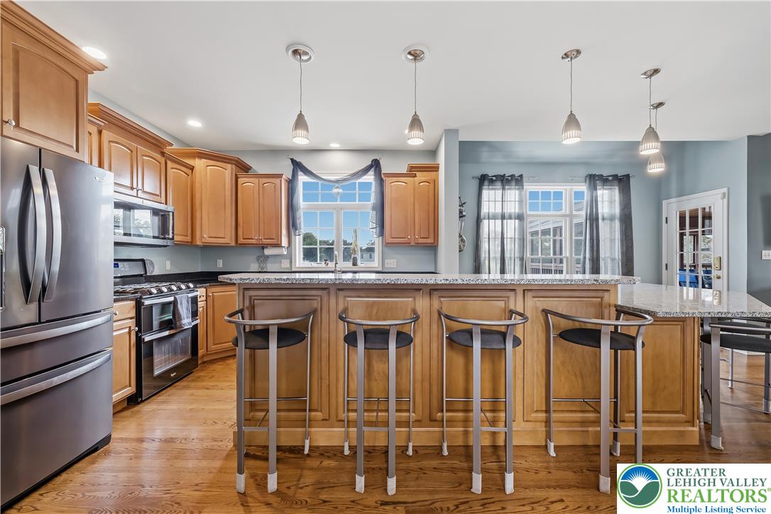 13 Country Road Northampton, PA 18067 - Photo 24 of 71 A well-appointed kitchen features rich wooden cabinetry, granite countertops, and modern stainless steel appliances.