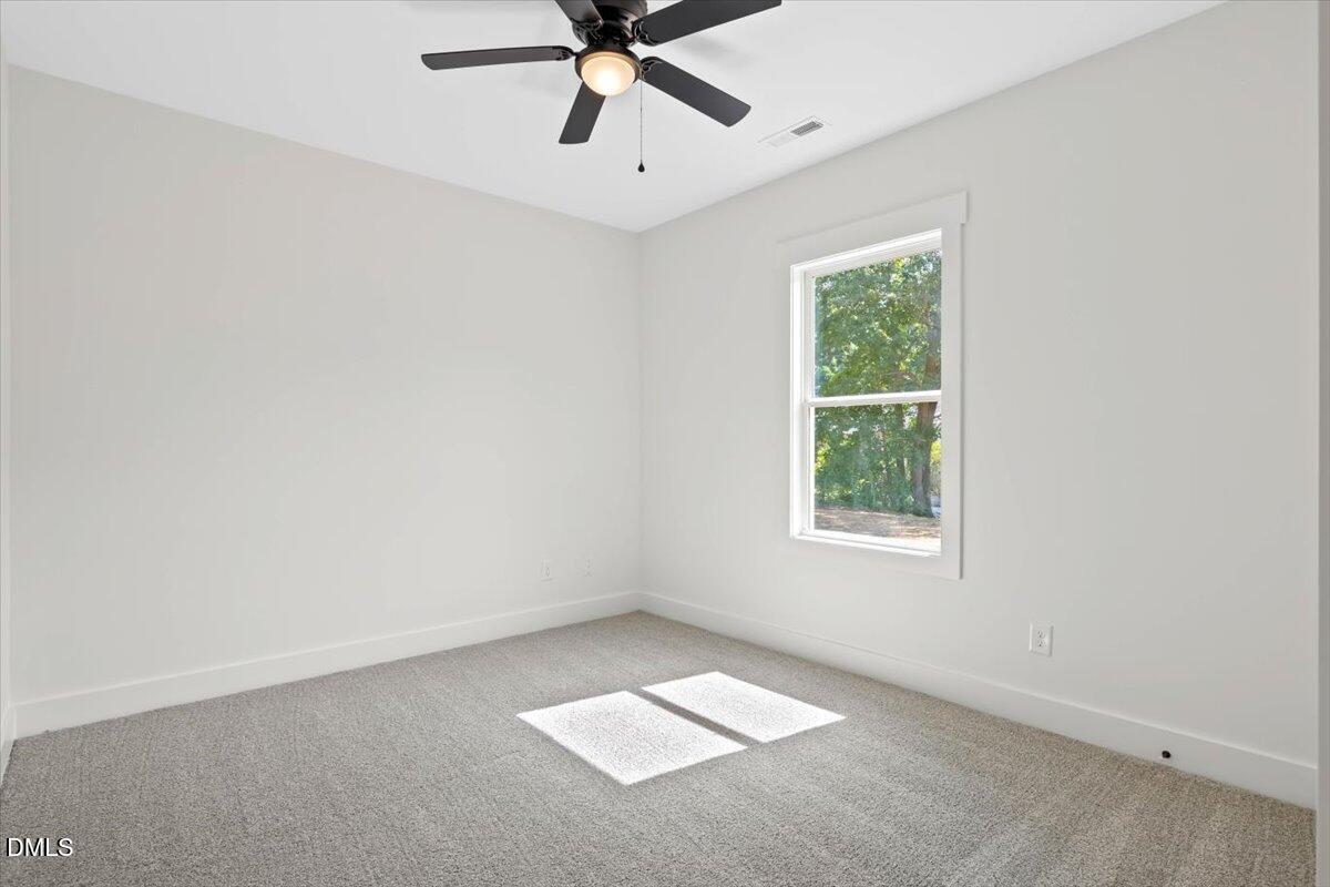 1655 Bunnlevel Erwin Road Bunnlevel, NC 28323 - Photo 20 of 26 an empty room with a window and a fan