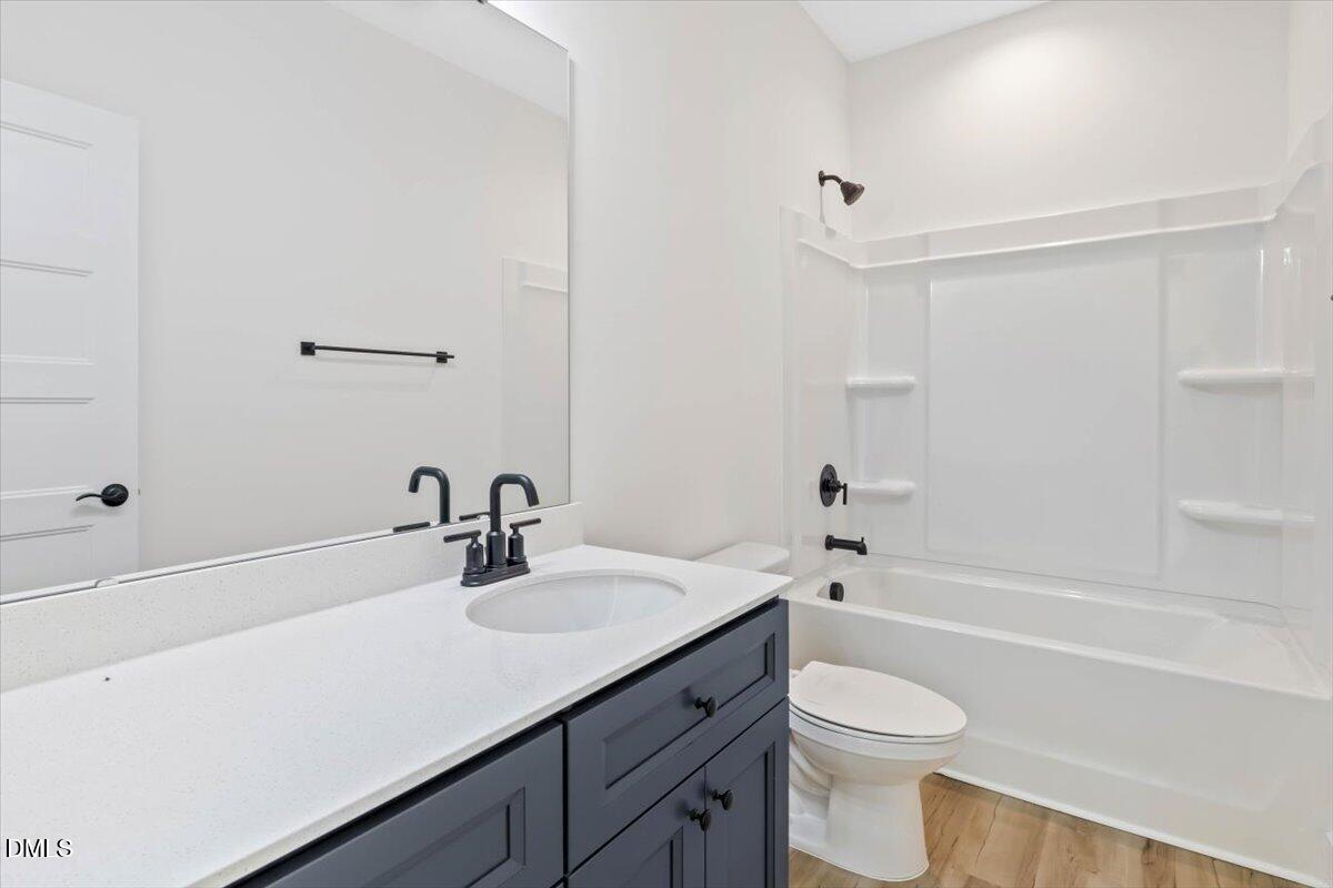 1655 Bunnlevel Erwin Road Bunnlevel, NC 28323 - Photo 22 of 26 a bathroom with a sink a toilet and shower