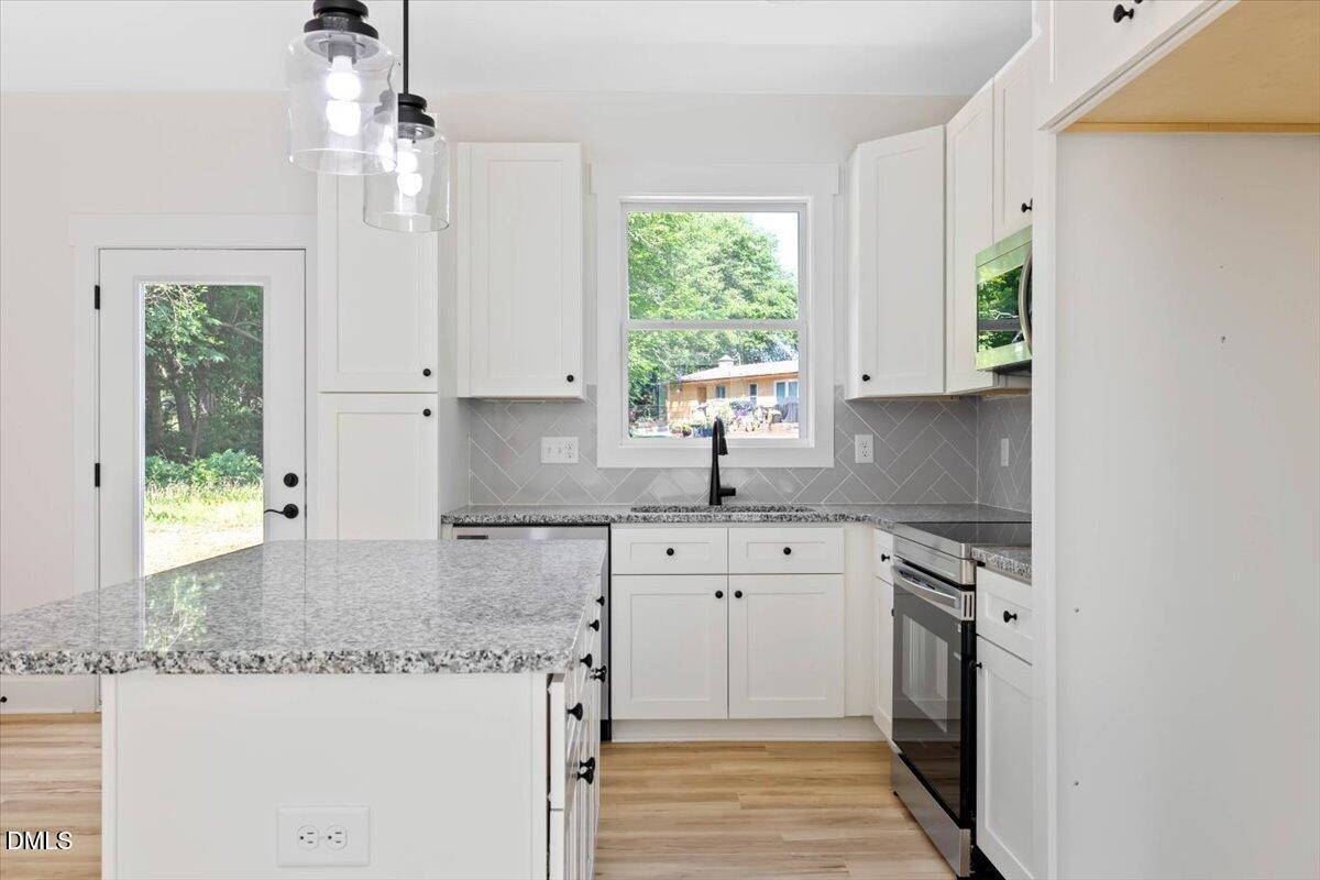 1655 Bunnlevel Erwin Road Bunnlevel, NC 28323 - Photo 8 of 26 a kitchen with a sink stove and window