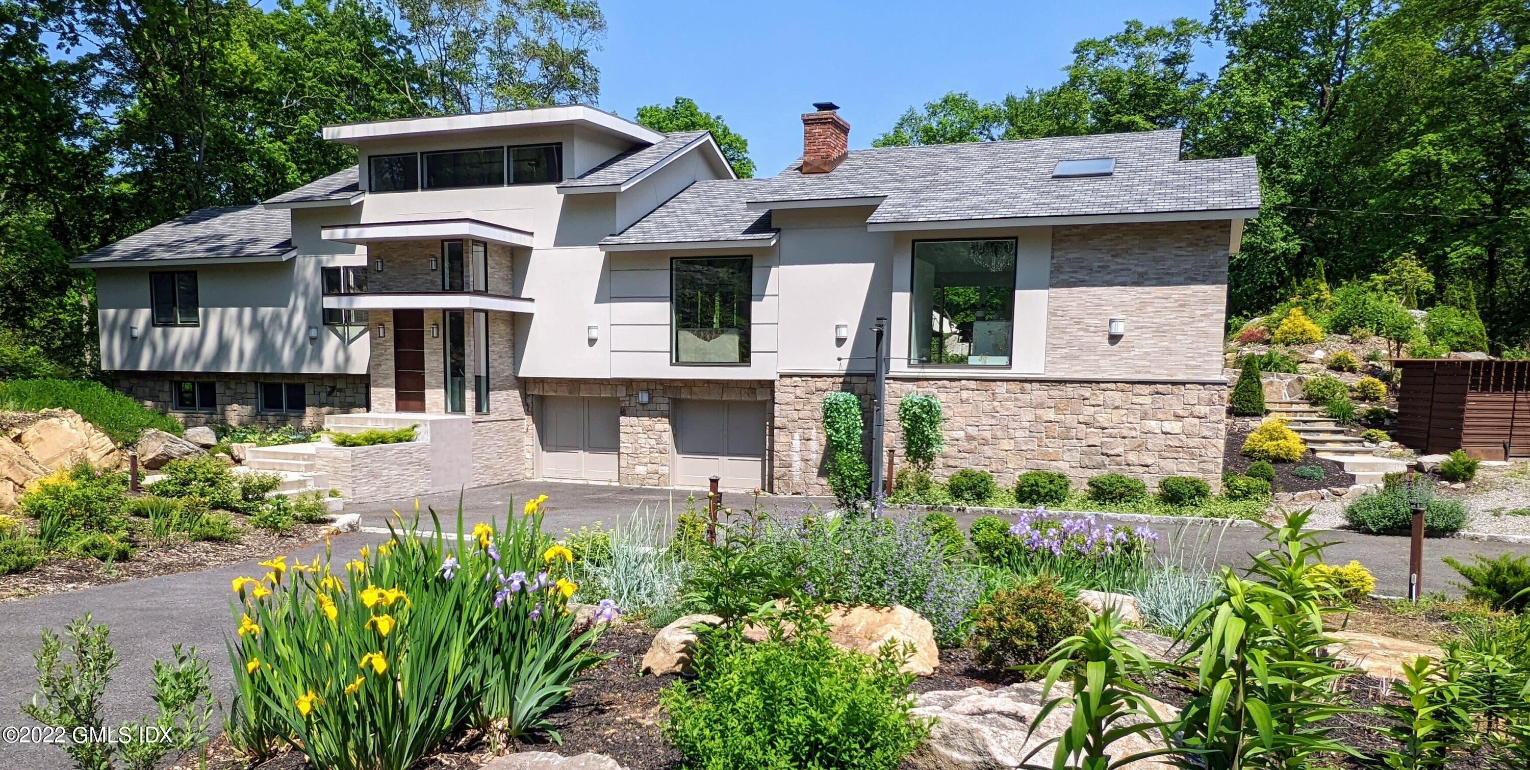 39 Nutmeg Drive Greenwich, CT 06831 - Photo 1 of 31 a front view of a house with garden