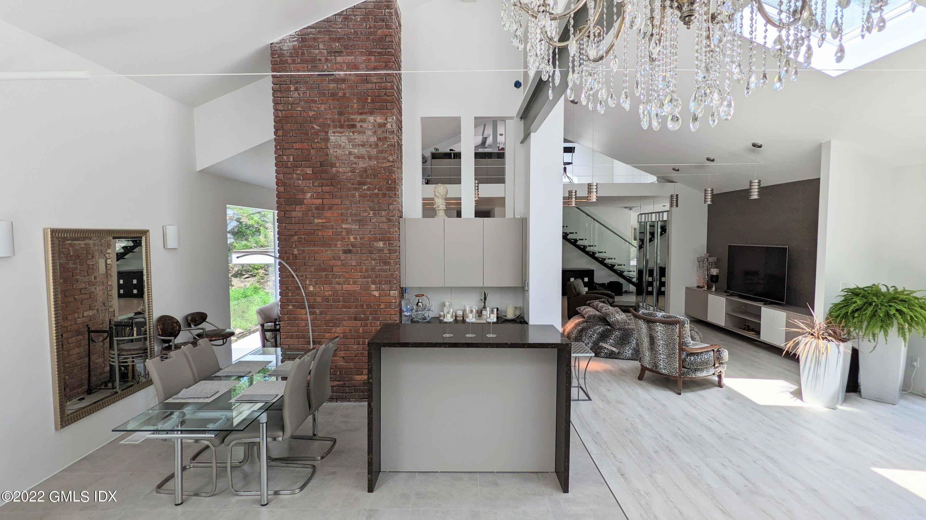 39 Nutmeg Drive Greenwich, CT 06831 - Photo 11 of 31 a living room with furniture a dining table with wooden floor