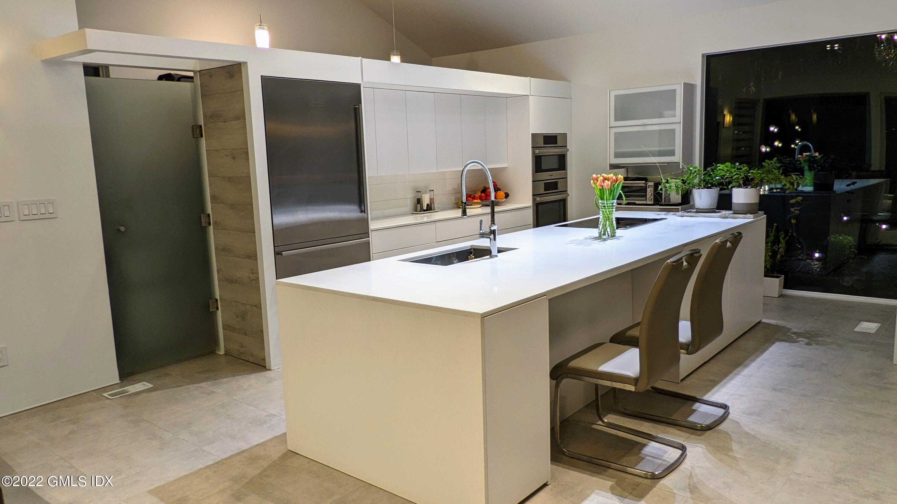 39 Nutmeg Drive Greenwich, CT 06831 - Photo 16 of 31 a kitchen with a sink appliances and cabinets