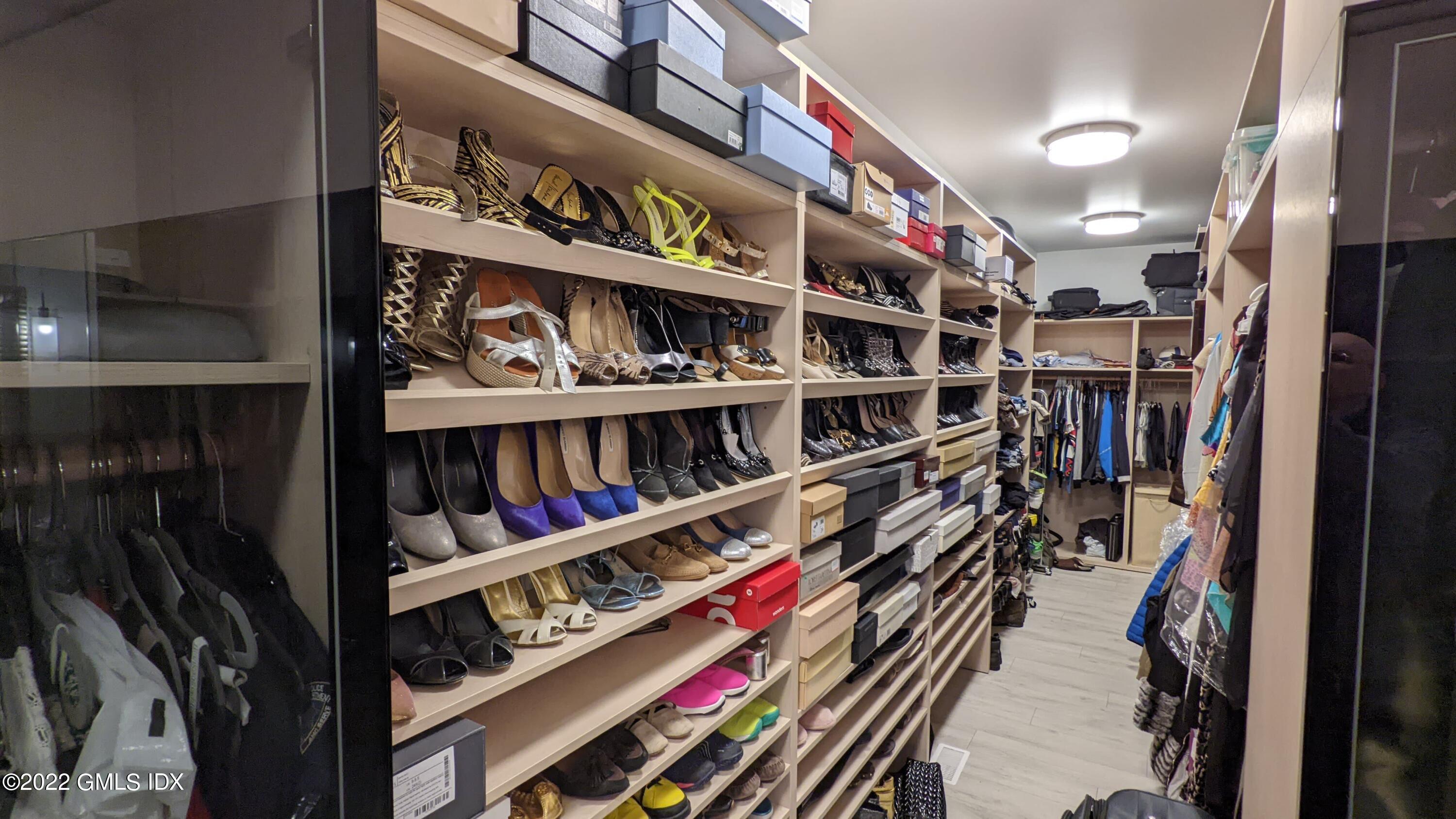 39 Nutmeg Drive Greenwich, CT 06831 - Photo 20 of 31 a view of walk in closet with clothes and shoes