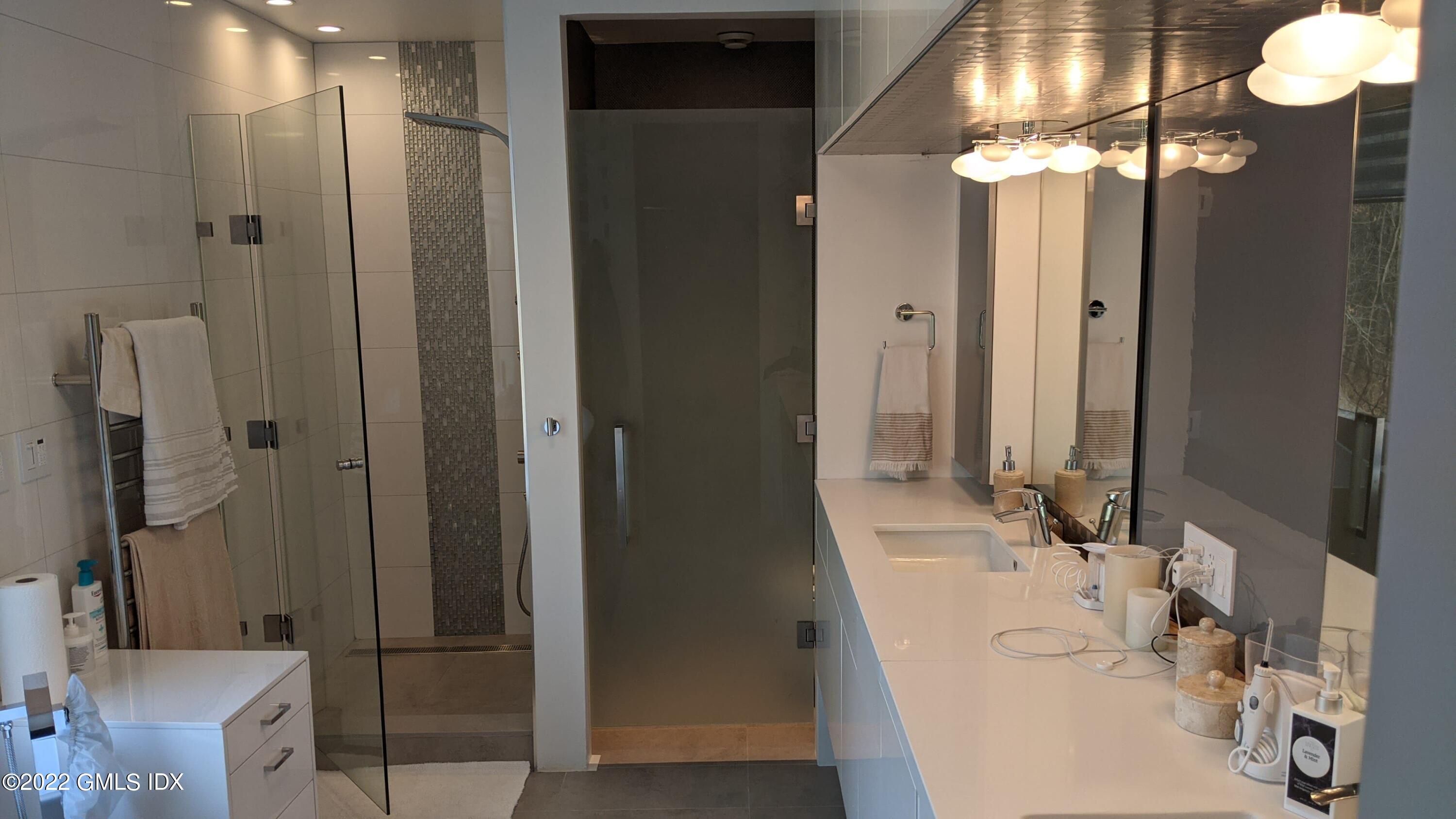 39 Nutmeg Drive Greenwich, CT 06831 - Photo 21 of 31 a bathroom with double vanity and a mirror