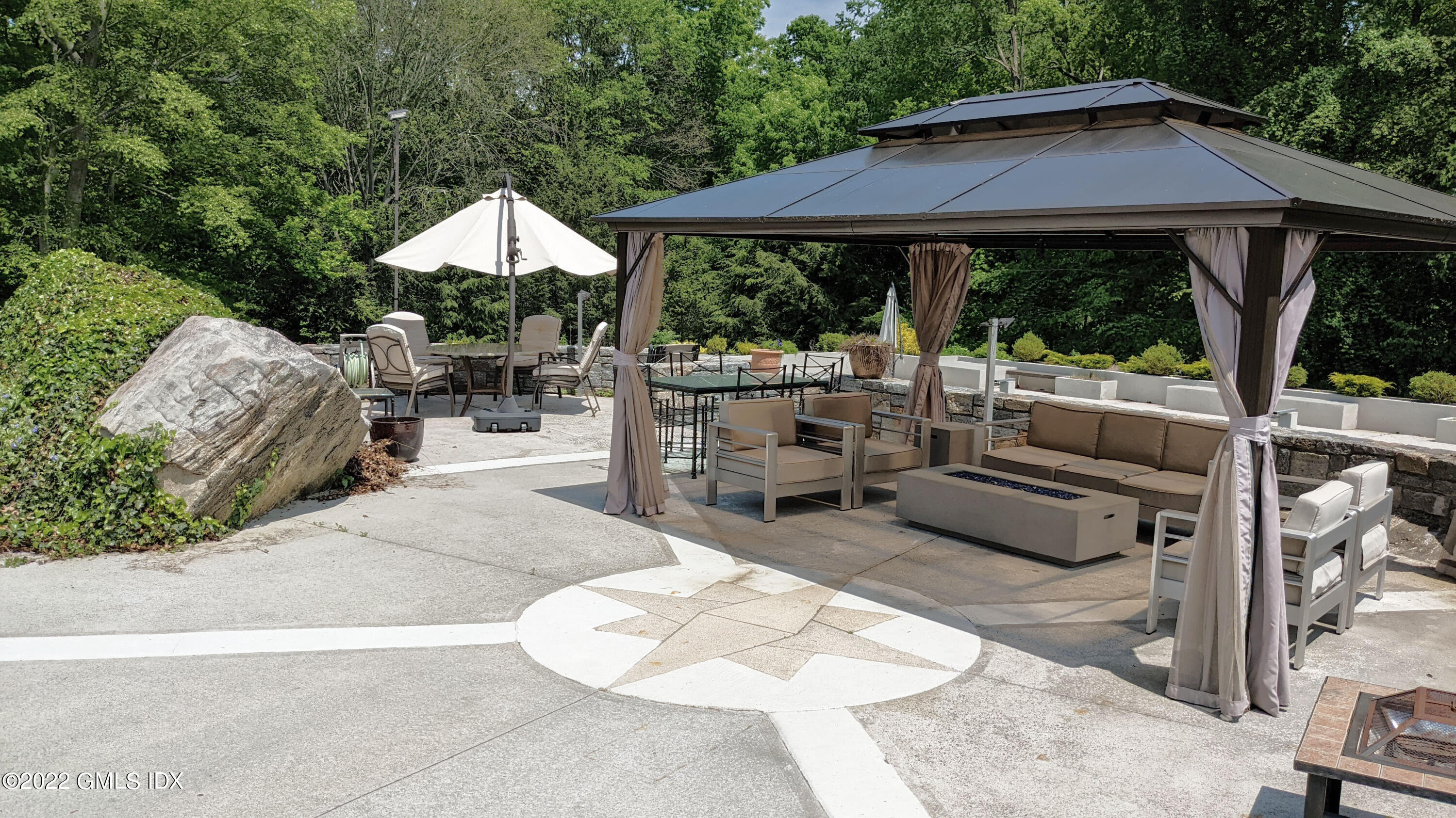 39 Nutmeg Drive Greenwich, CT 06831 - Photo 26 of 31 a view of backyard with outdoor seating and trees