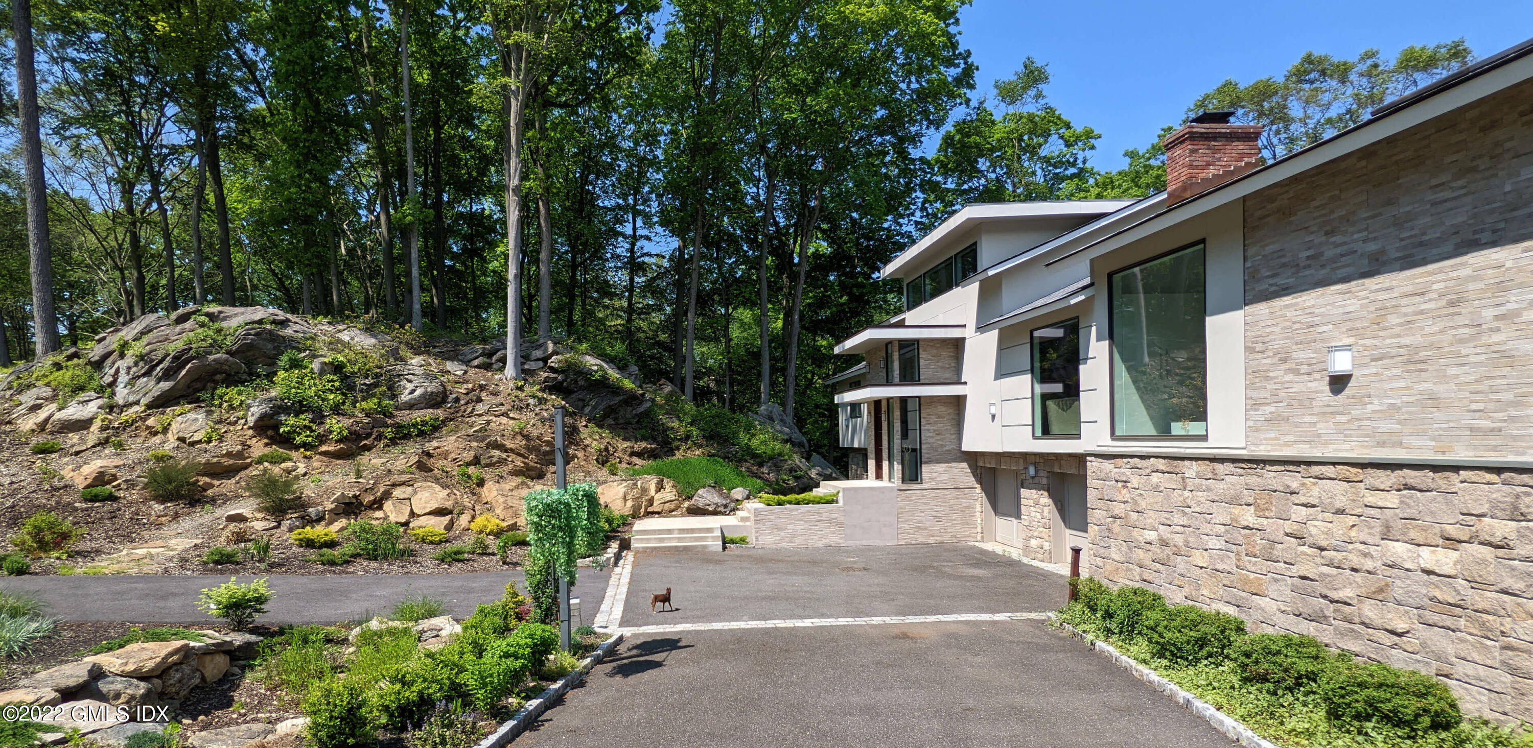 39 Nutmeg Drive Greenwich, CT 06831 - Photo 4 of 31 a view of a garden with a bench in the patio