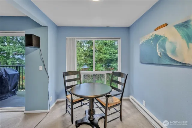 a view of a dining room with furniture and a window