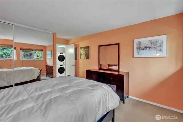 a bedroom with a large bed and a dresser