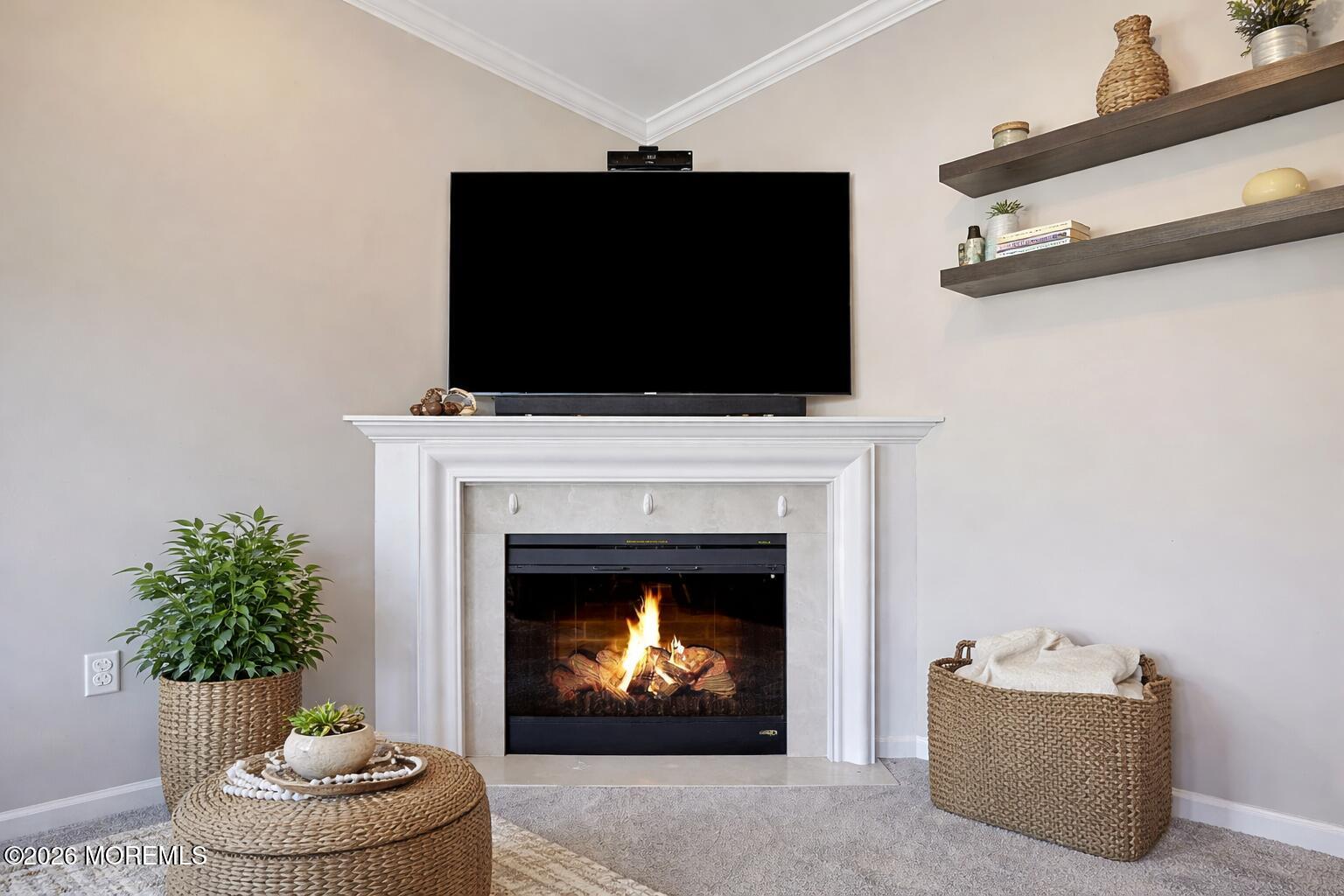 631 Sloan Court Matawan, NJ 07747 - Photo 4 of 10 a living room with a fireplace a flat screen tv and a fireplace