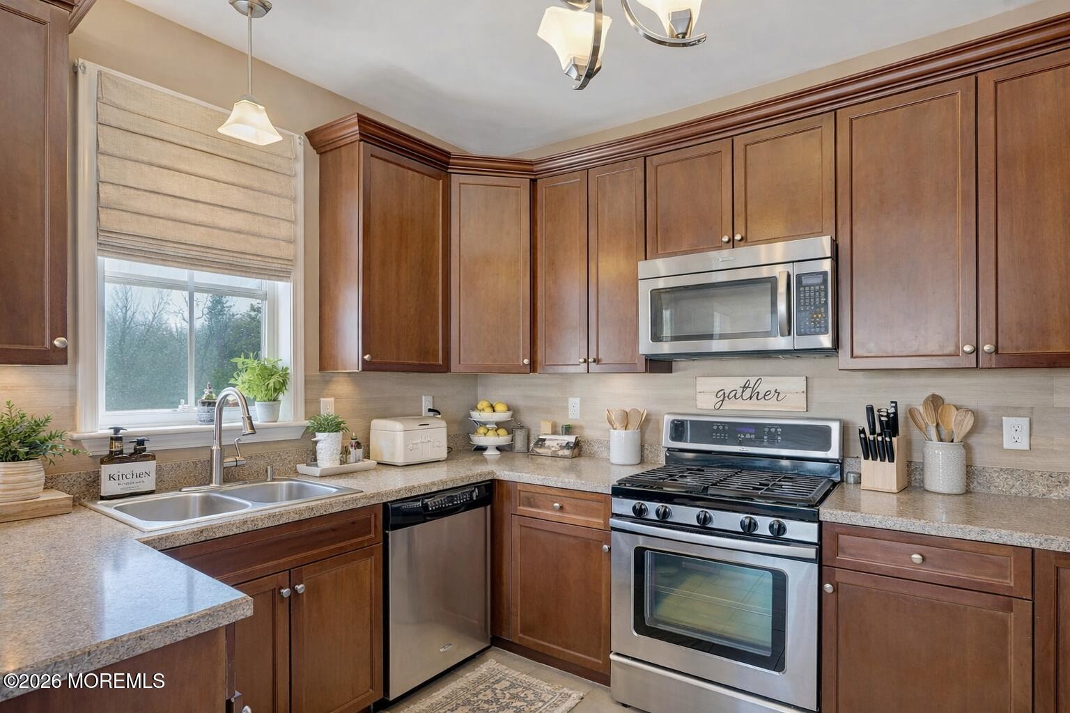 631 Sloan Court Matawan, NJ 07747 - Photo 5 of 10 a kitchen with stainless steel appliances granite countertop a sink a stove and cabinets
