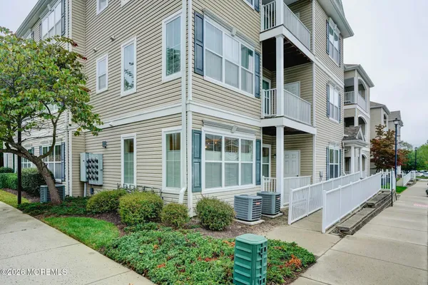 a front view of a house with a yard outdoor seating and pathway