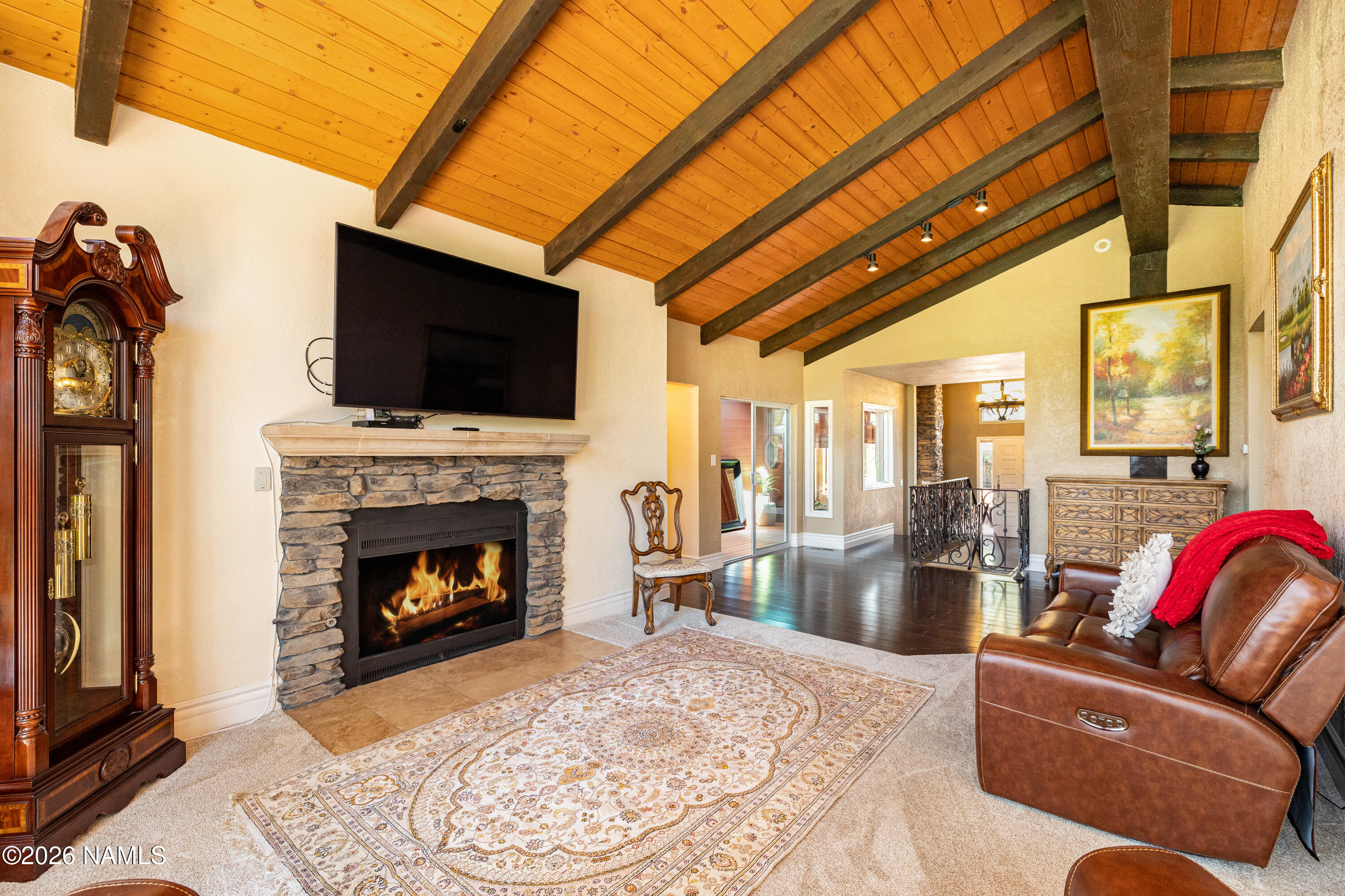1407 North Mariposa Road Flagstaff, AZ 86004 - Photo 12 of 85 a living room with furniture a flat screen tv and a fireplace