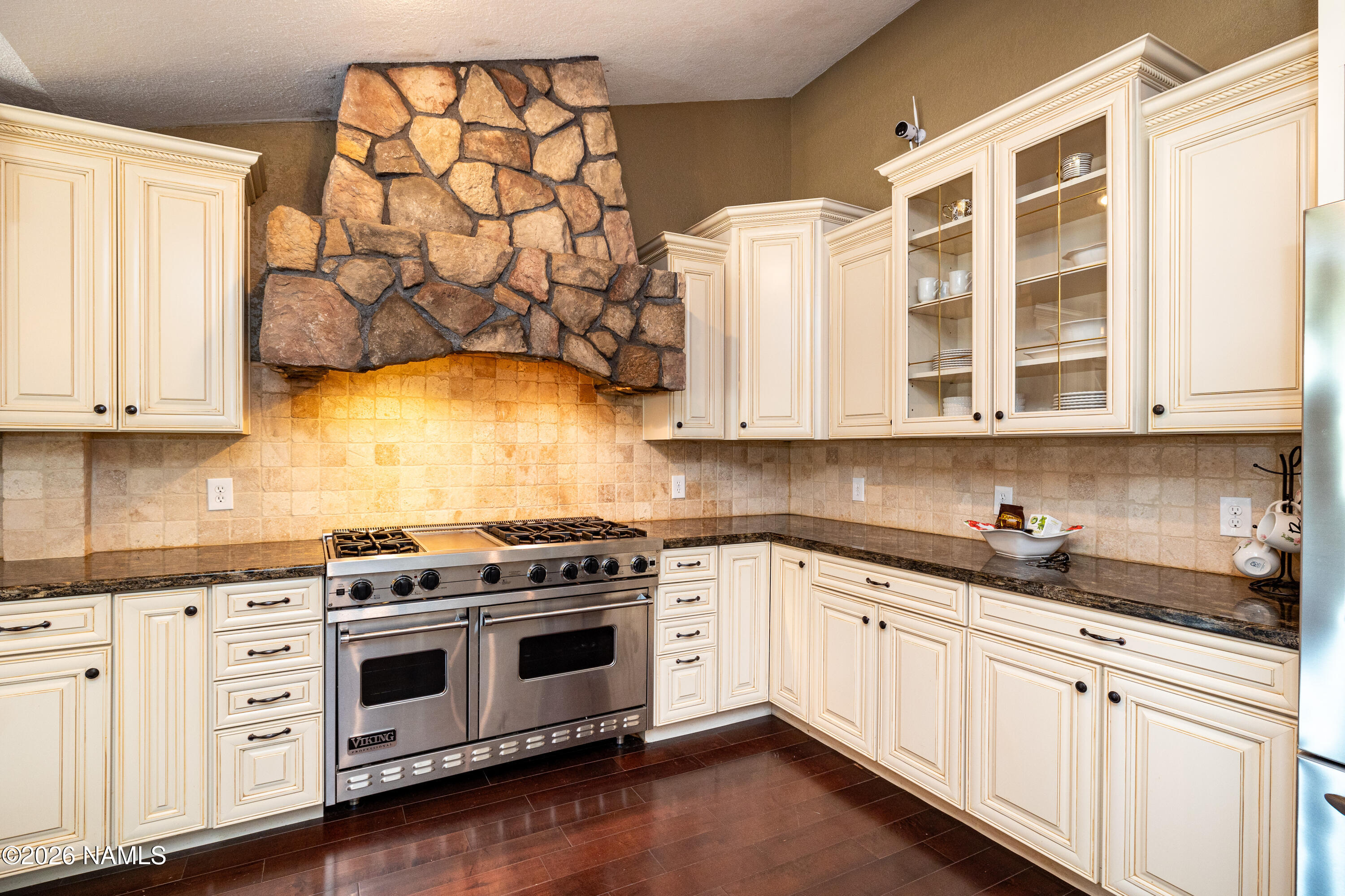 1407 North Mariposa Road Flagstaff, AZ 86004 - Photo 16 of 85 a kitchen with stainless steel appliances granite countertop a stove a sink and a microwave