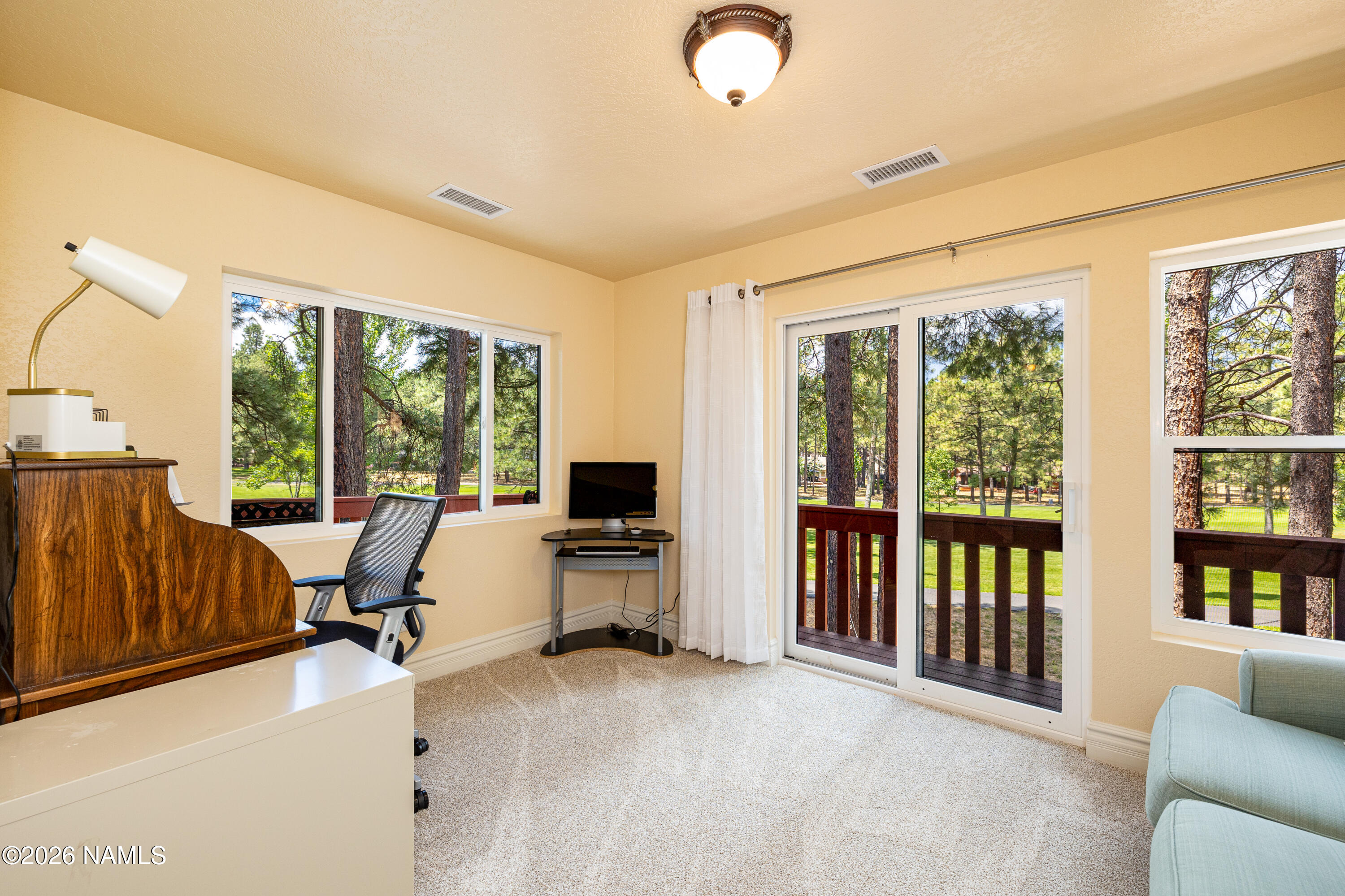 1407 North Mariposa Road Flagstaff, AZ 86004 - Photo 32 of 85 a view of a livingroom with furniture and floor to ceiling window