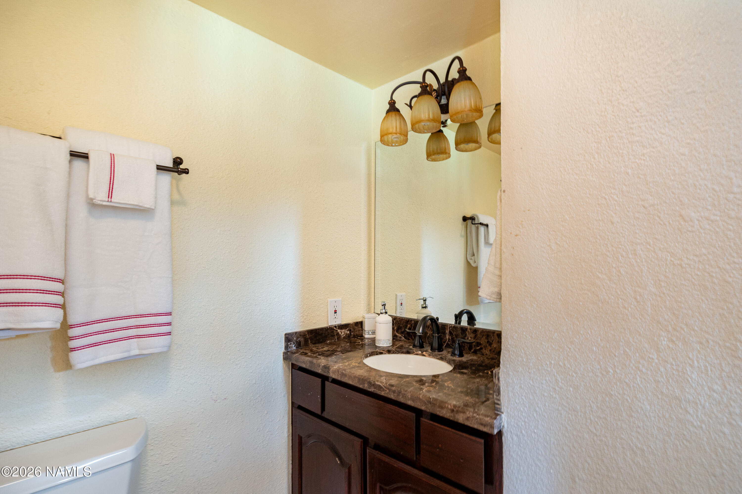 1407 North Mariposa Road Flagstaff, AZ 86004 - Photo 43 of 85 a bathroom with a granite countertop sink and a mirror