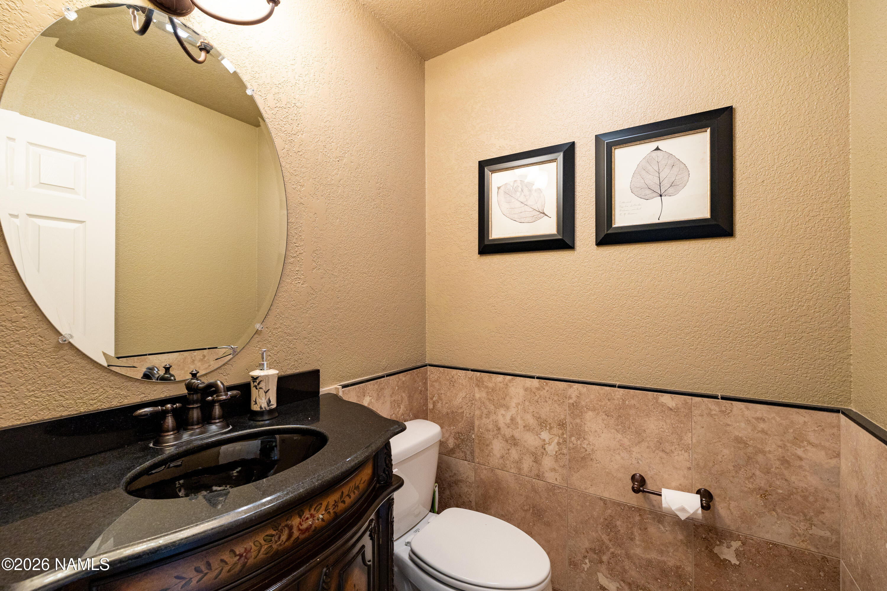 1407 North Mariposa Road Flagstaff, AZ 86004 - Photo 50 of 85 a bathroom with a sink mirror vanity and toilet