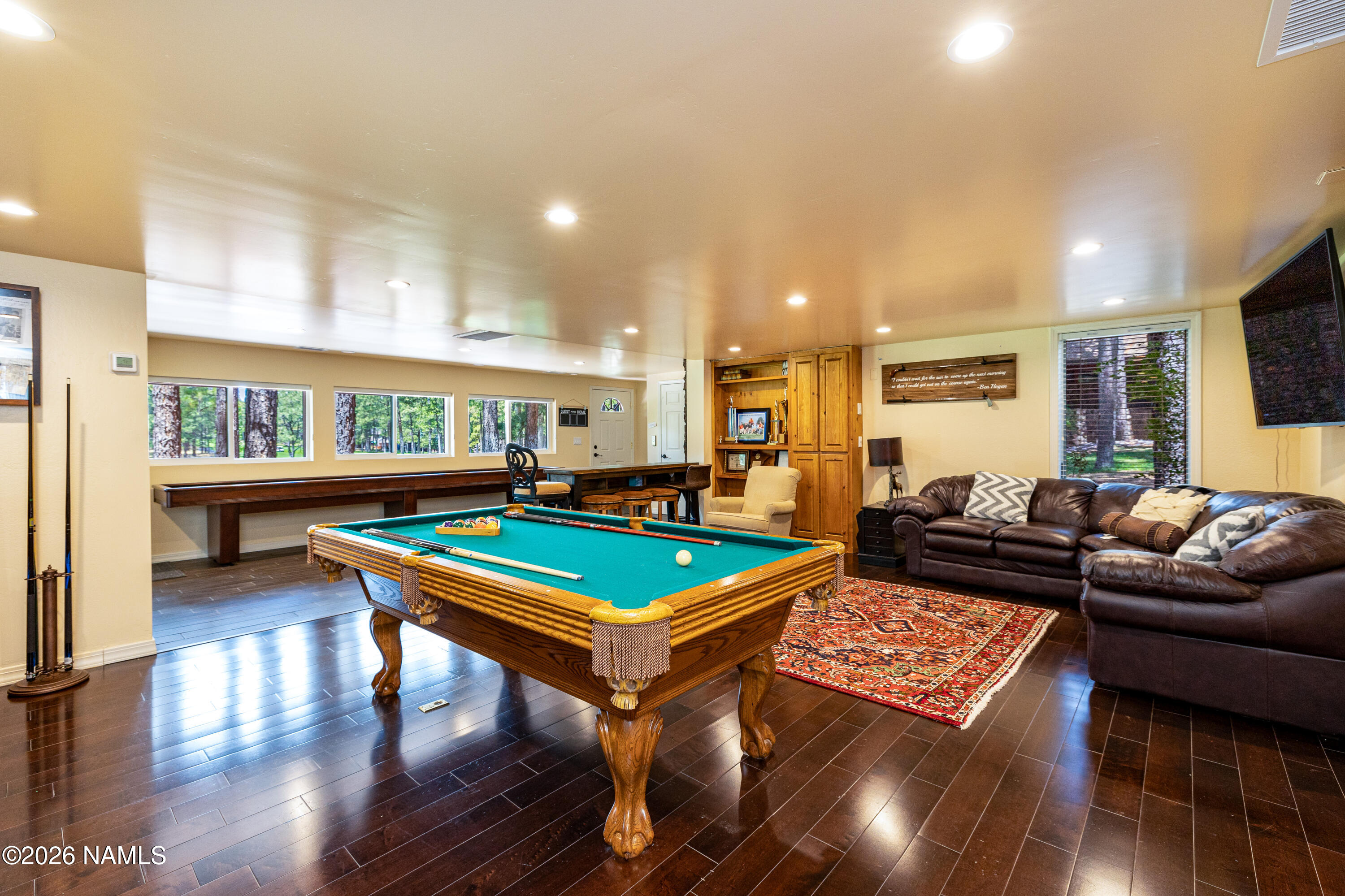 1407 North Mariposa Road Flagstaff, AZ 86004 - Photo 51 of 85 a living room with furniture a pool table and a flat screen tv