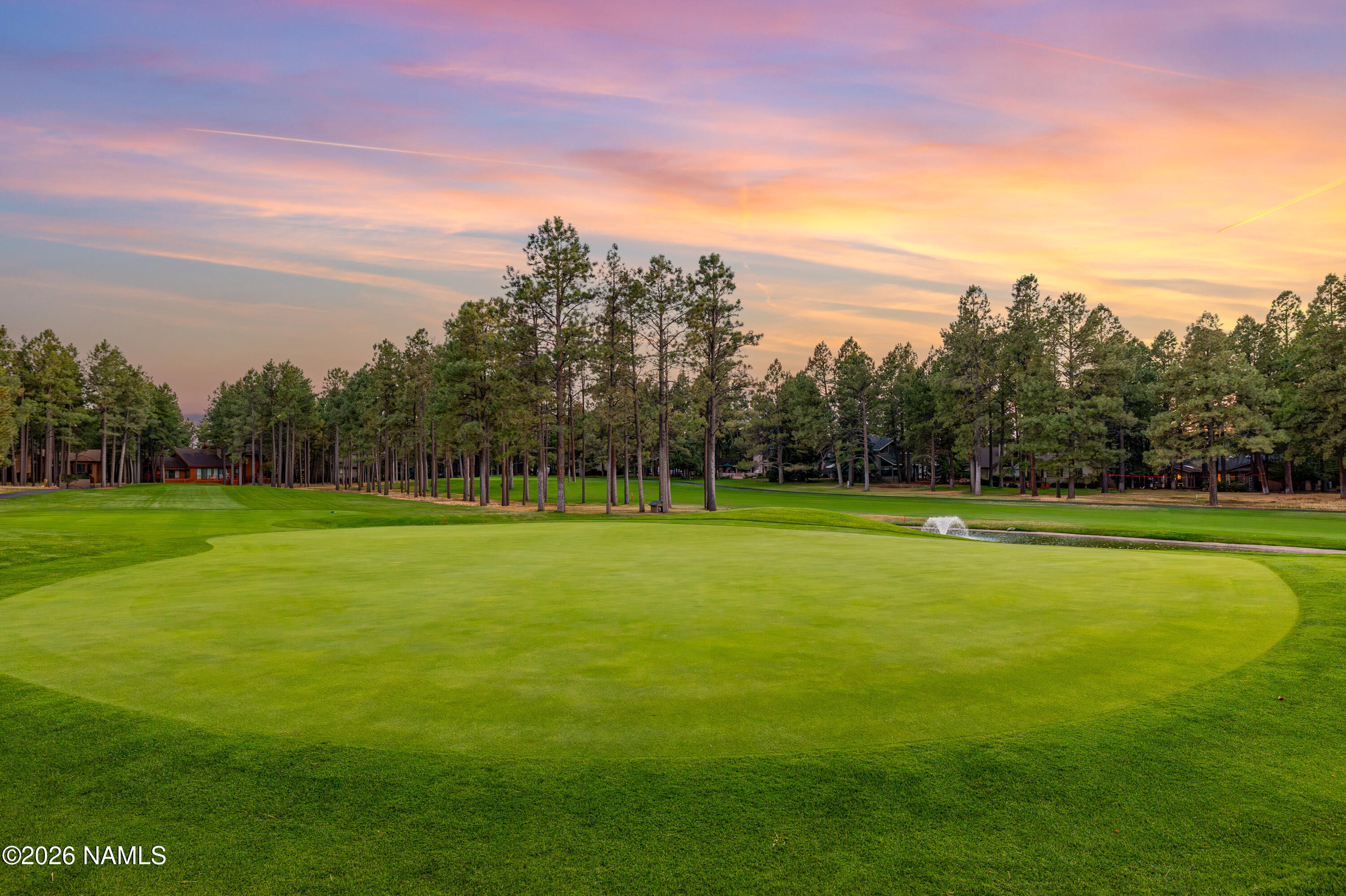 1407 North Mariposa Road Flagstaff, AZ 86004 - Photo 70 of 85 a view of a golf course with a lake