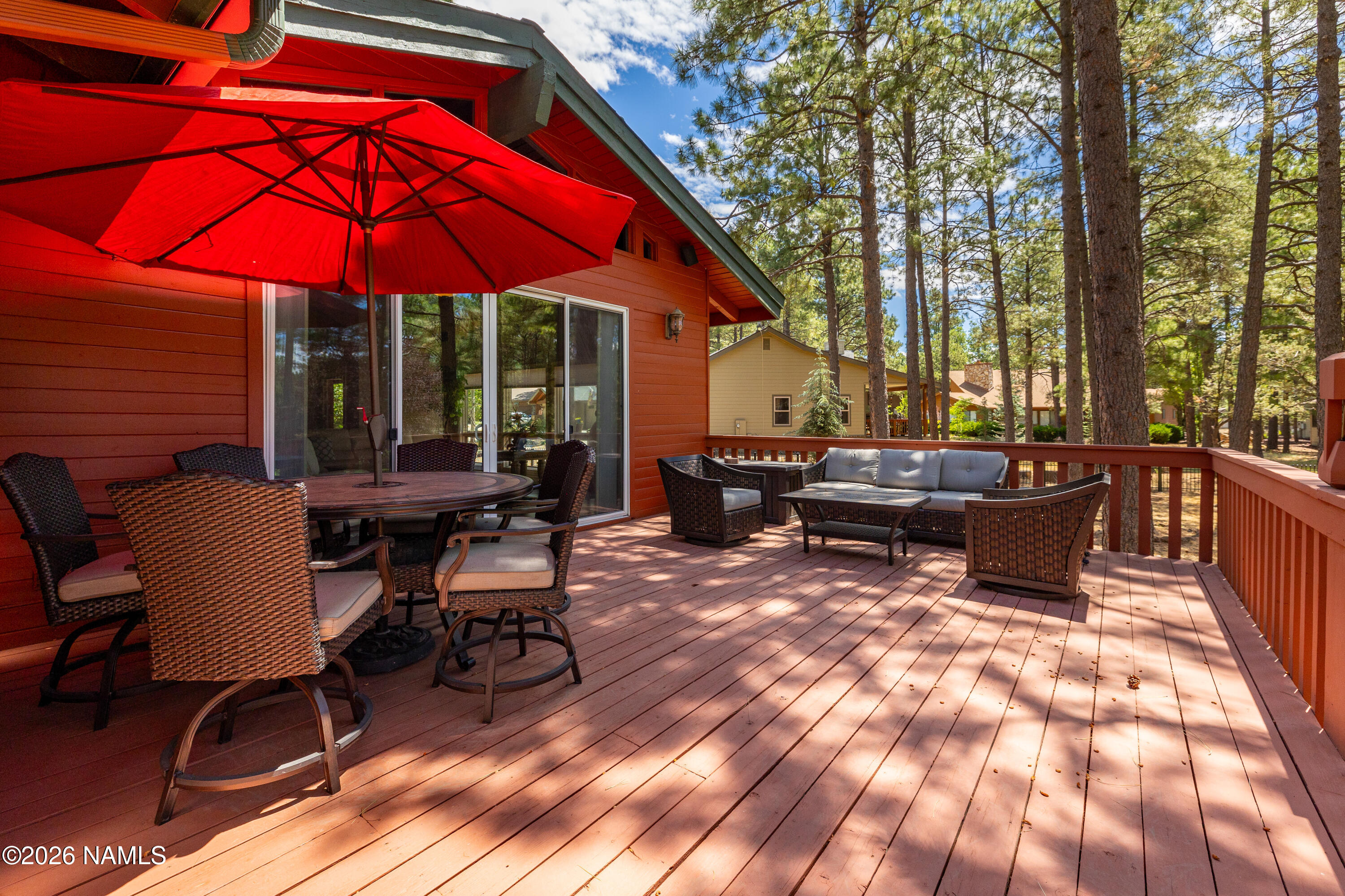 1407 North Mariposa Road Flagstaff, AZ 86004 - Photo 8 of 85 a view of a patio with a table and chairs under an umbrella
