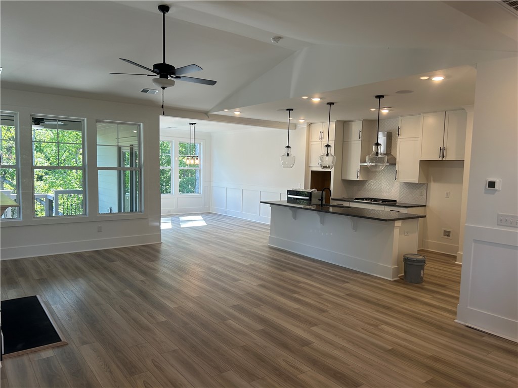 131 Shale Drive Central, SC 29630 - Photo 3 of 11 This expansive open concept living area seamlessly integrates the kitchen with rich wood flooring.