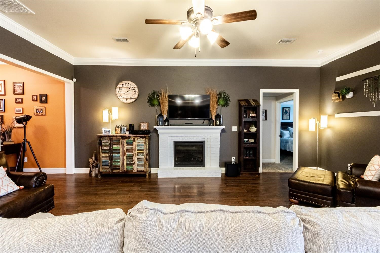 9301 Rochester Avenue Lubbock, TX 79424 - Photo 13 of 49 a living room with furniture a flat screen tv and a fireplace