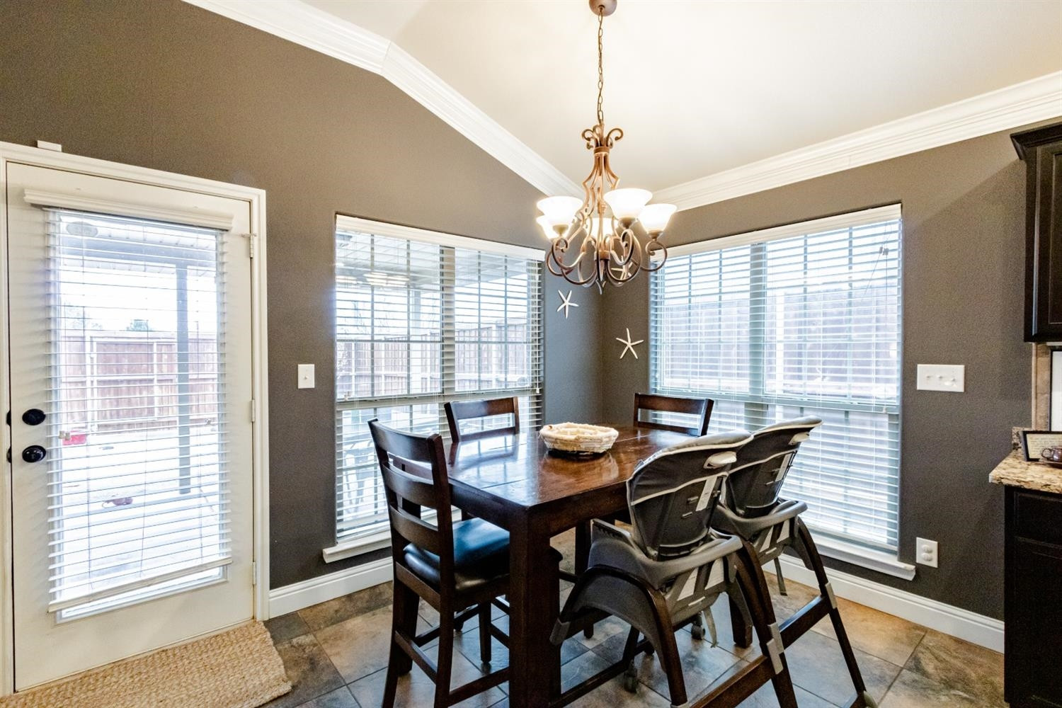 9301 Rochester Avenue Lubbock, TX 79424 - Photo 21 of 49 a view of a dining room with furniture wooden floor and chandelier