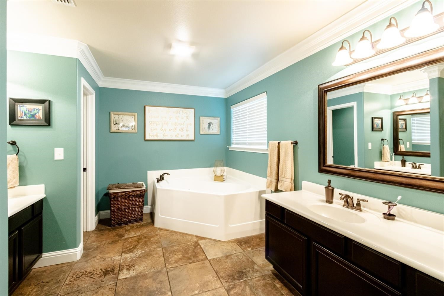 9301 Rochester Avenue Lubbock, TX 79424 - Photo 25 of 49 a bathroom with a tub sink and mirror