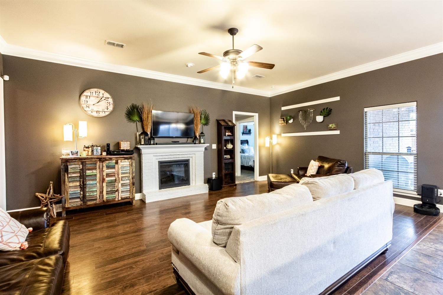 9301 Rochester Avenue Lubbock, TX 79424 - Photo 3 of 49 a living room with furniture a fireplace and a flat screen tv